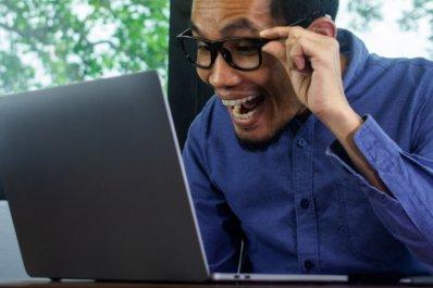 Happy bidder in front of his computer