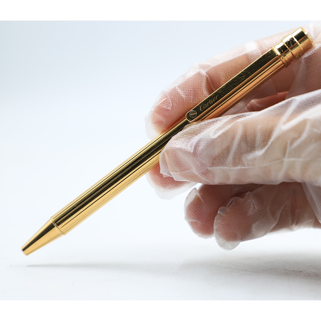Santos de Cartier ballpoint pen, small model, body in 18K gold (750/1000)-finish metal with gadroon motif 344224
