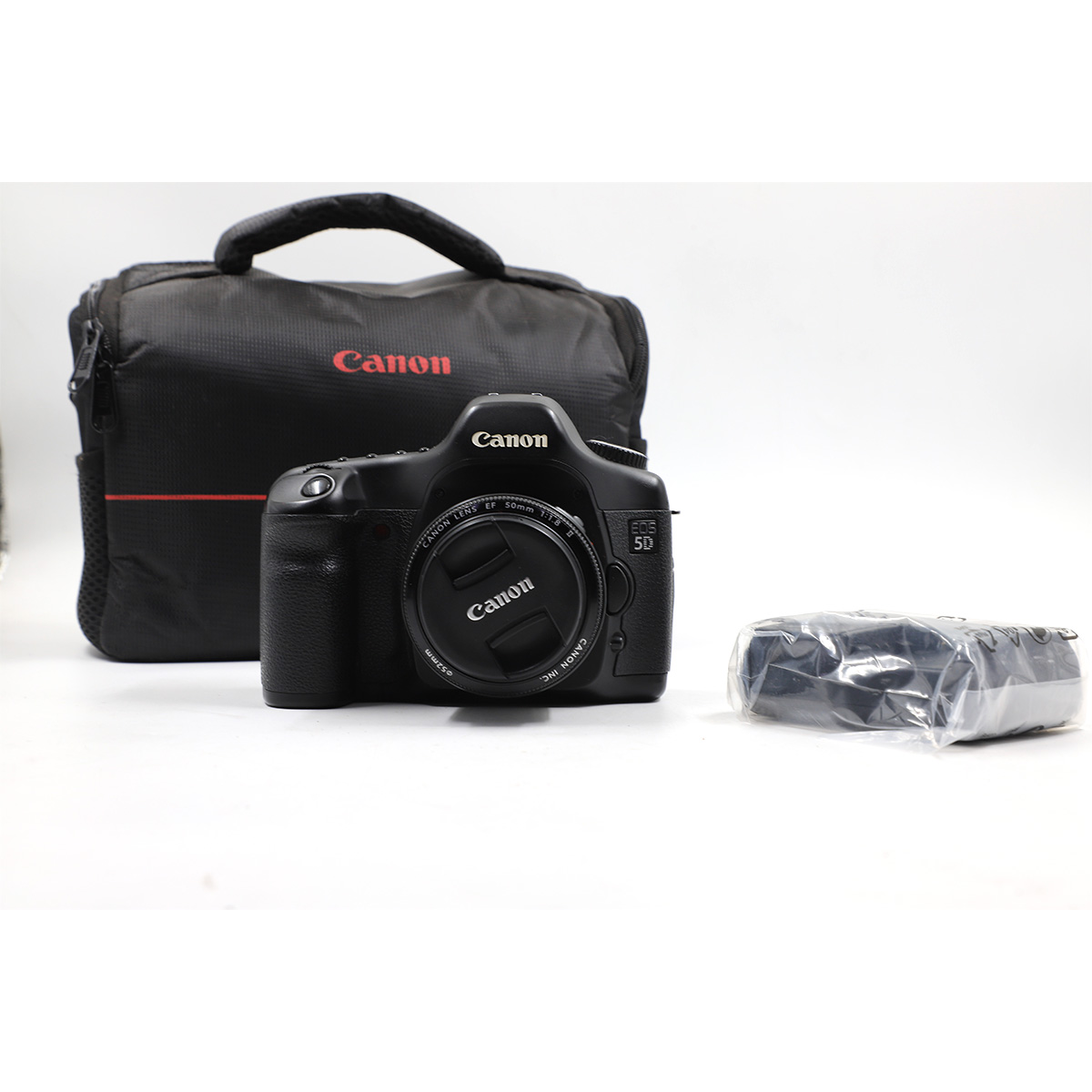 Auction For Canon EOS 5D + Canon Lens EF 50 mm 1:1.8 II  + Charger + Pouch Doesn’t Include the Battery